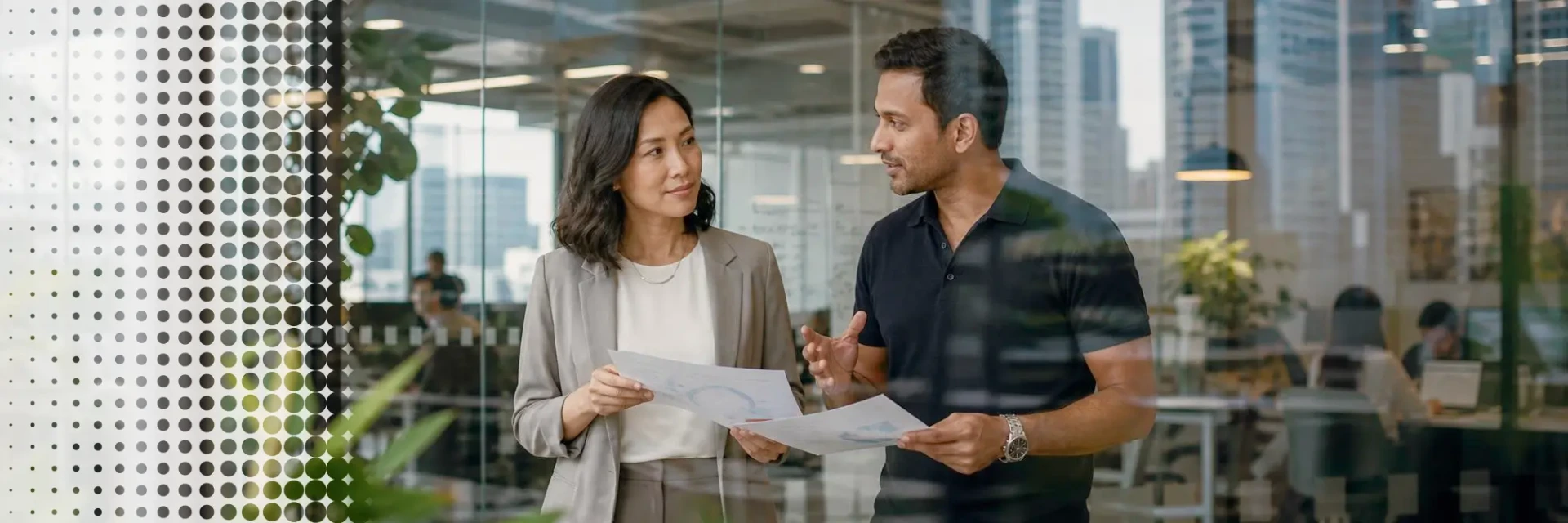 Two business professionals reviewing expansion plans in a modern Singapore office.