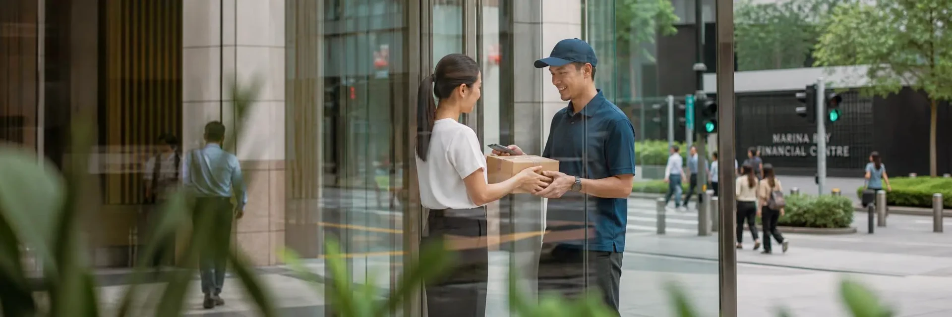 Courier handing a parcel to a customer in Singapore’s Marina Bay business district.