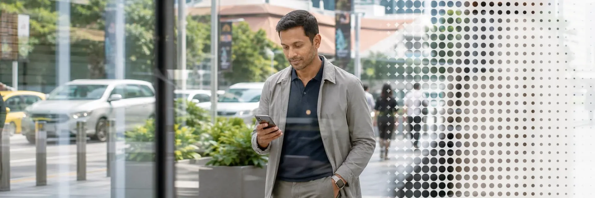 Business professional using a smartphone in Singapore’s urban commercial district